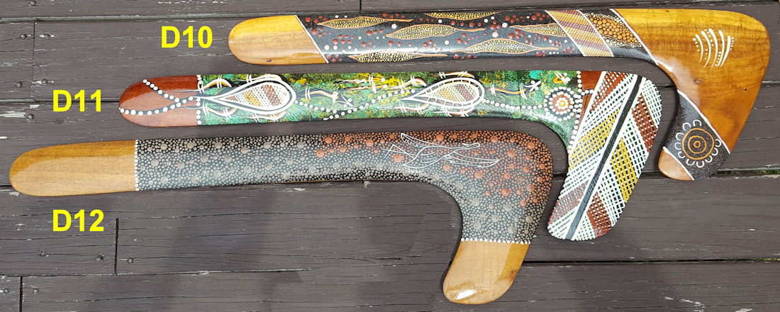 Hook boomerangs painted by aboriginal artist with elements of fine dot art and crosshatch - Aboriginal art painting techniques.